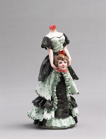 A porcelain figurine of a woman holding her own head, by Shary Boyle.