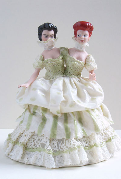 A porcelain figurine of a woman with two heads, by Shary Boyle.