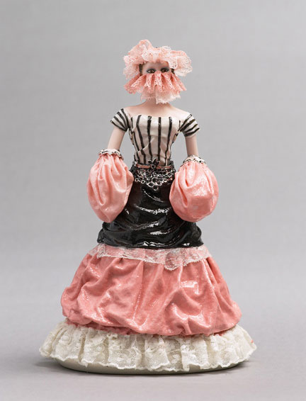 A porcelain figurine of a woman being drowned in the fabric of her own dress, by Shary Boyle.