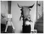 Pablo Picasso wearing a bull's mask.