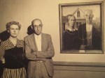 Models for Grant Wood's American Gothic pose with the iconic painting.