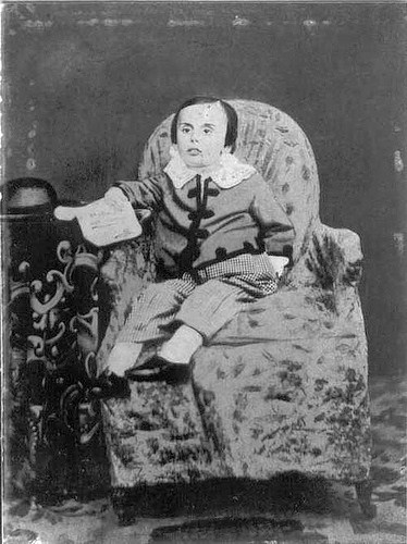 Victorian photograph of a child with mother disguised in the background.