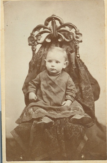 Victorian photograph of a child with mother disguised in the background.