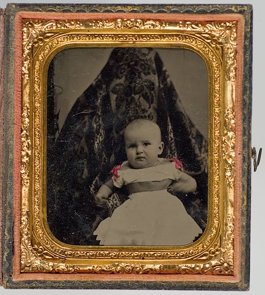 Victorian photograph of a child with mother disguised in the background.