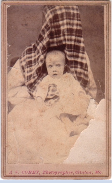 Victorian photograph of a child with mother disguised in the background.
