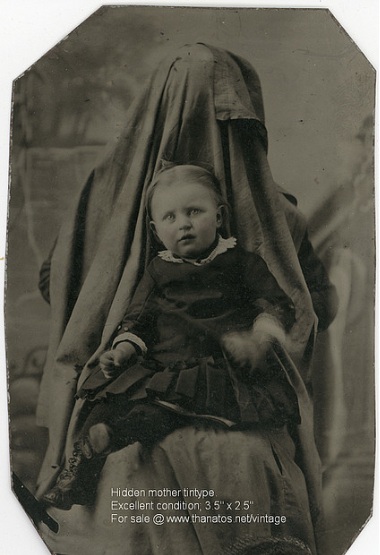 Victorian photograph of a child with mother disguised in the background.