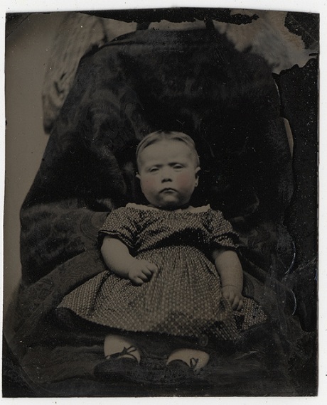 Victorian photograph of a child with mother disguised in the background.