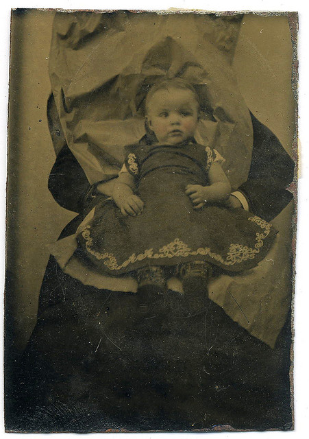 Victorian photograph of a child with mother disguised in the background.
