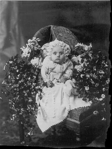 Victorian photograph of a child with mother disguised in the background.