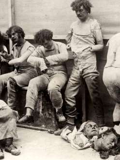 Photograph of six wax figures and broken body parts damaged from fire.